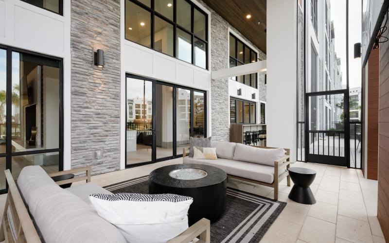 a living room with a large glass door and a large white couch